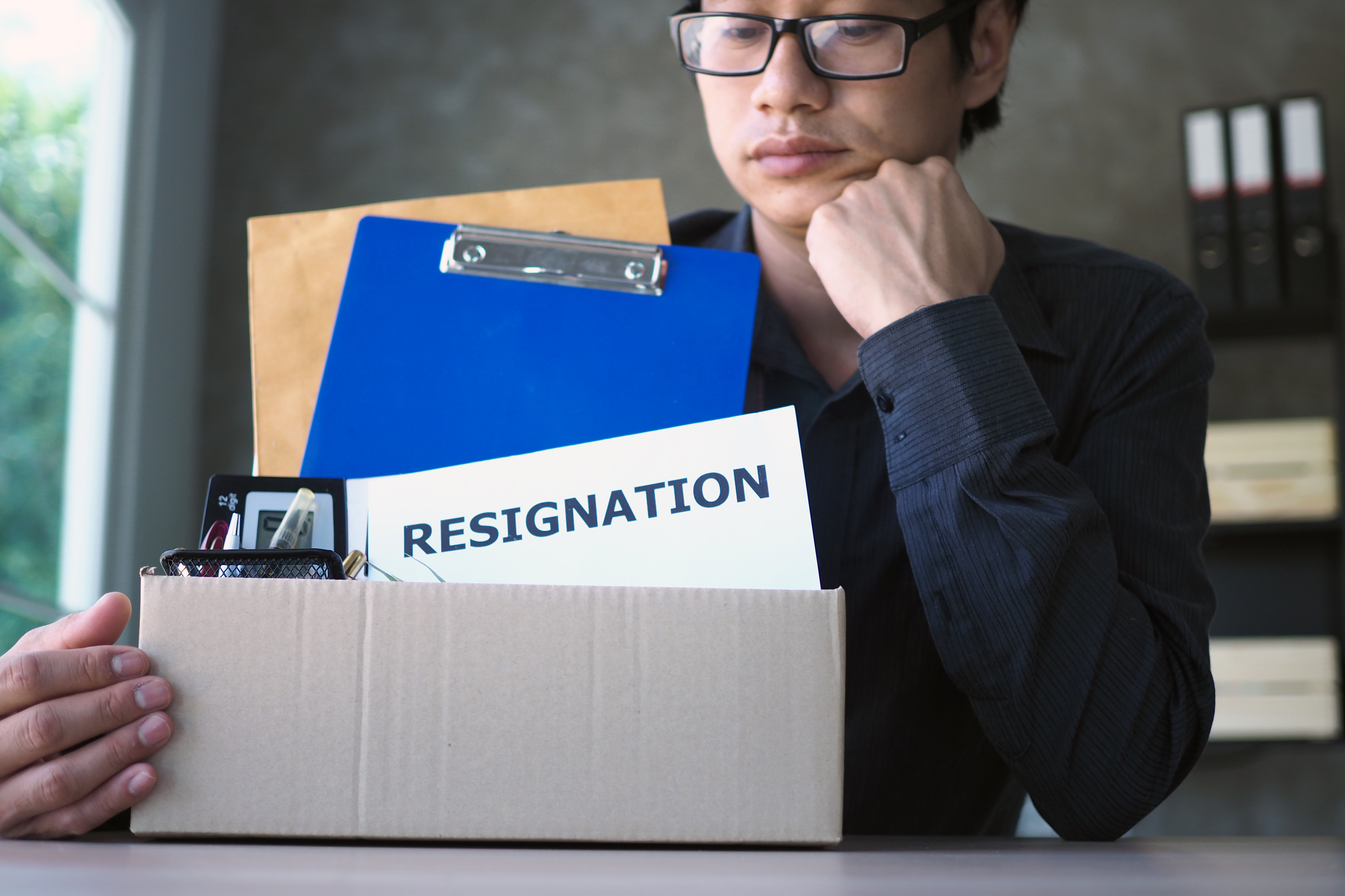 A man is thinking with resignation letter